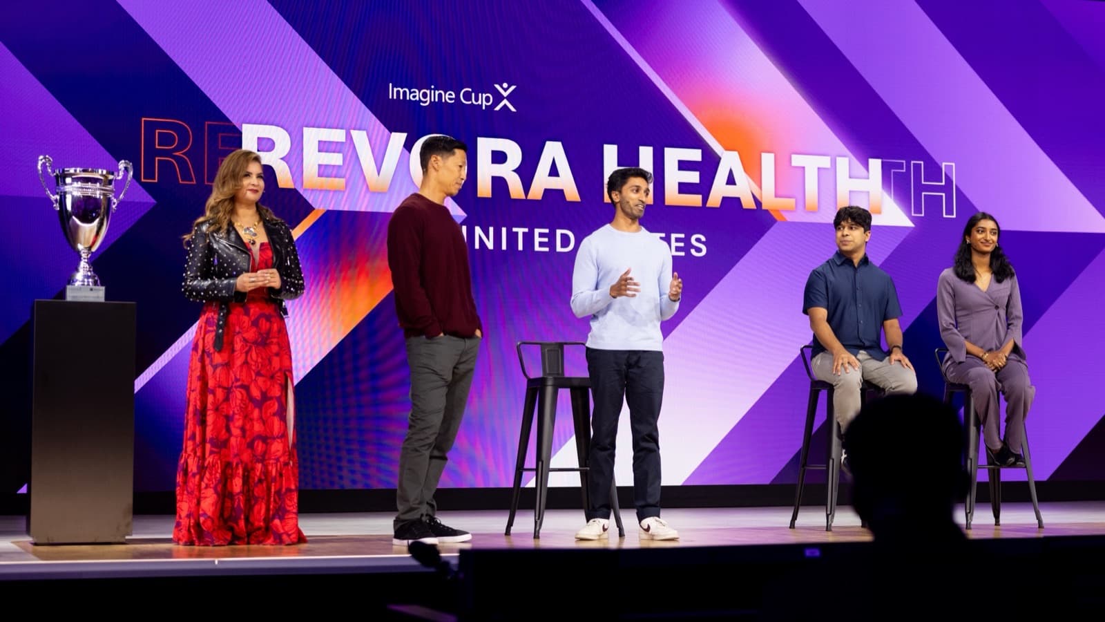 Surya Kukkapalli on the Imagine Cup World Championship stage, Revora Health on the screen behind him.