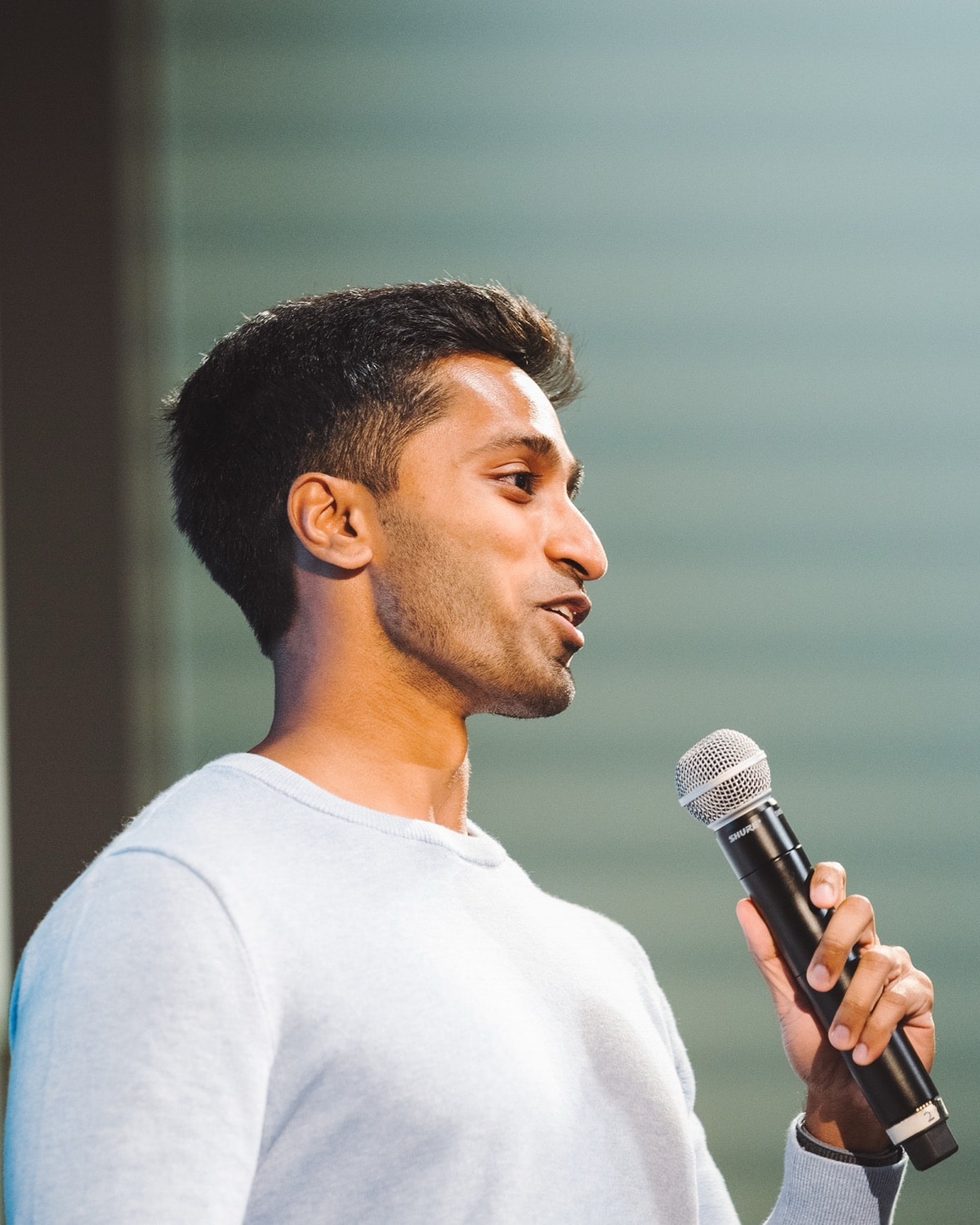 Surya Kukkapalli, in profile, speaking into a microphone.
